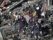Rescue workers at building collapse site.